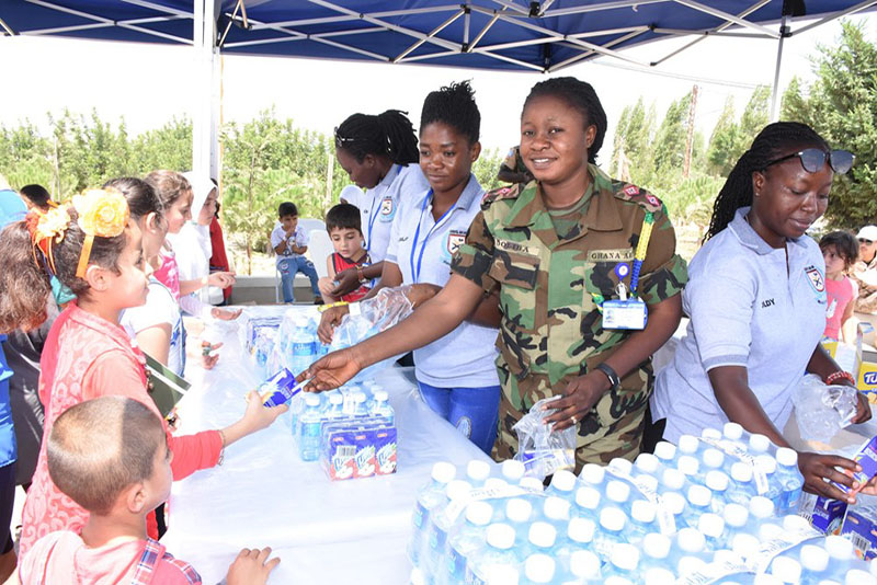 Lieutenant Lucy Doliba and her team distribute food supplies at a children's festival in Tibnin.