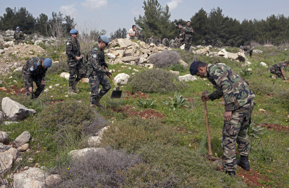 Lebanese Armed Forces soldiers and UNIFIL peacekeepers planting trees during a reforestation campaign in Ebel es Saqi