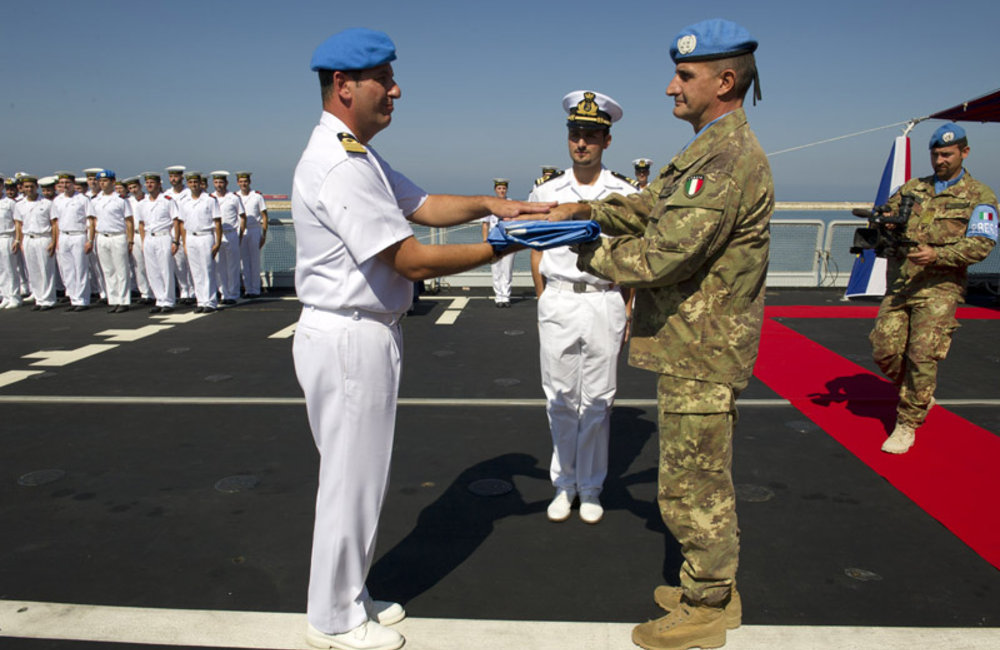 UNIFIL Head of Mission and Force Commander Major-General Paolo Serra hands over the United Nations flag to Captain (Navy) Gianfranco Annunziata on board of the Andrea Doria, the latest ship to join UNIFIL’s Maritime Task Force.
