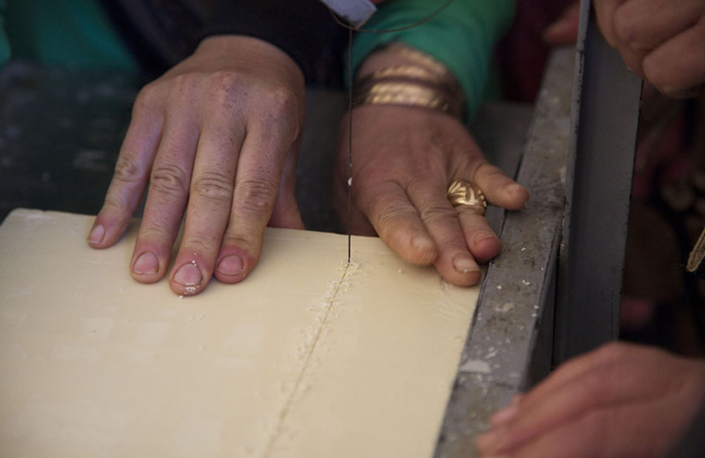 Women cutting freshly made soap in Ramieh, south Lebanon during a training financed by UNIFIL.