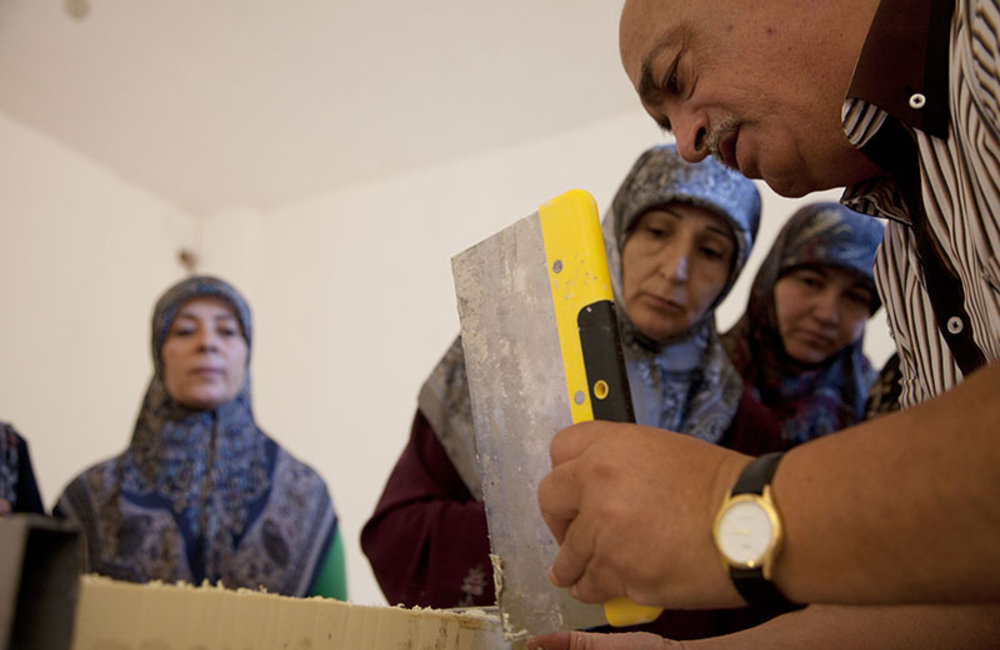 Women watching teacher levelling freshly made soap in Ramieh village, south Lebanon.