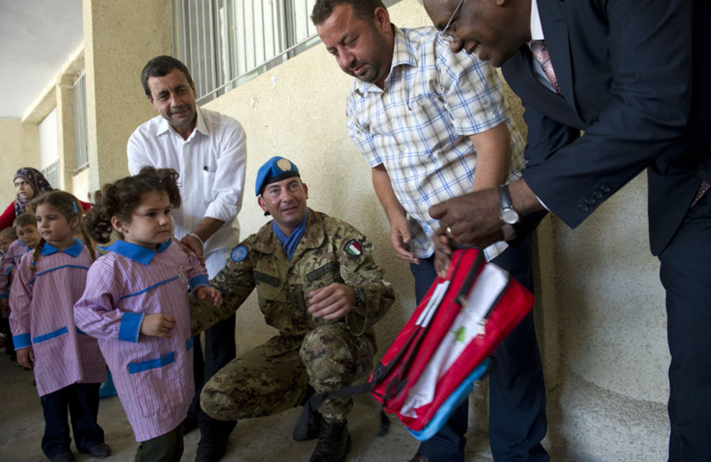 Albagir Adam, Chief of Civil Affairs handing out a school bag at Naqoura School, 05 November 2012