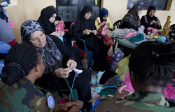 Ramieh learns knitting with Ghanaian battalion