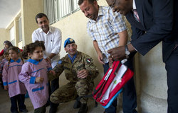 Albagir Adam, Chief of Civil Affairs handing out a school bag at Naqoura School, 05 November 2012