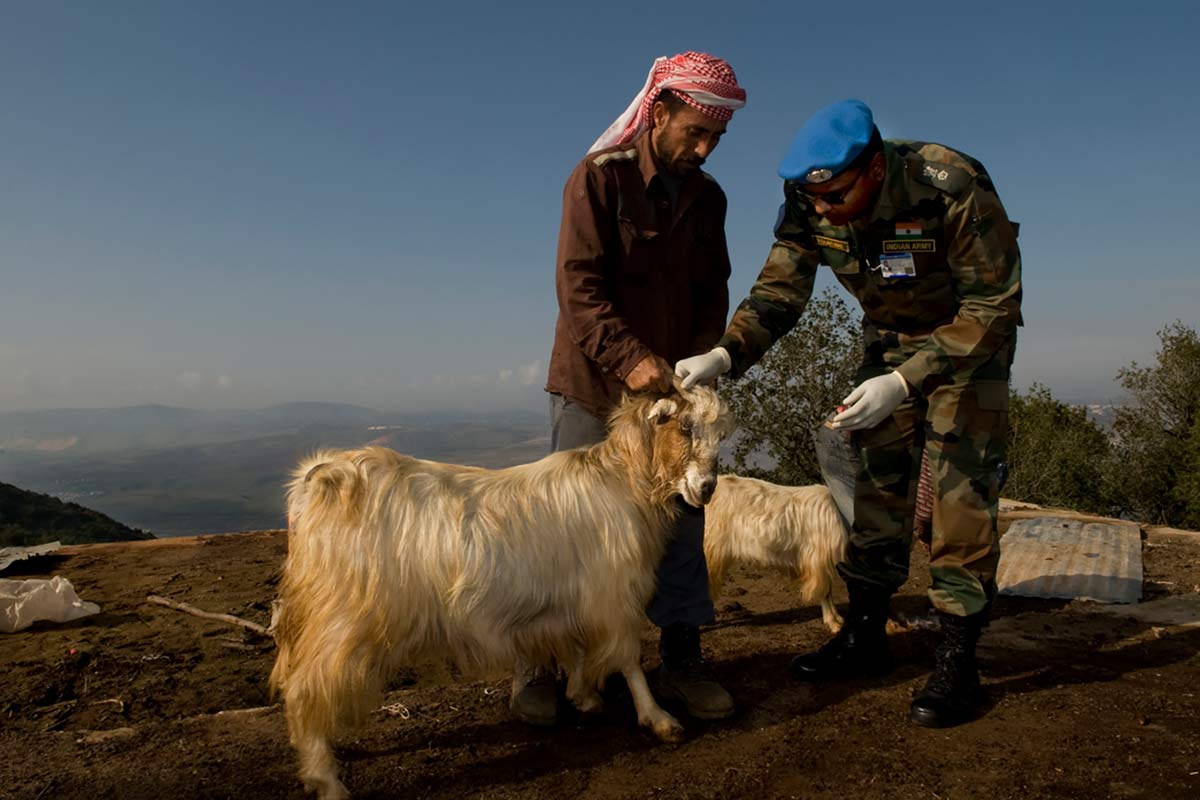 UNIFIL peacekeeper assisting community member