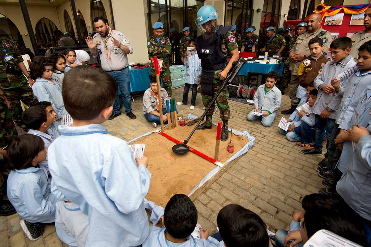 UNIFIL peacekeeper demonstrates de-mining to children