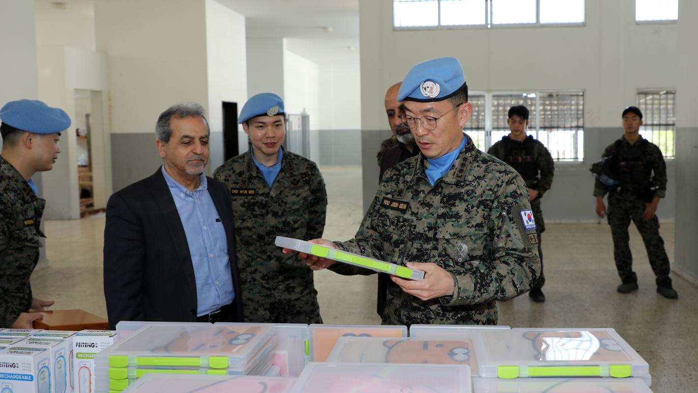 Peacekeepers standing in front of a table