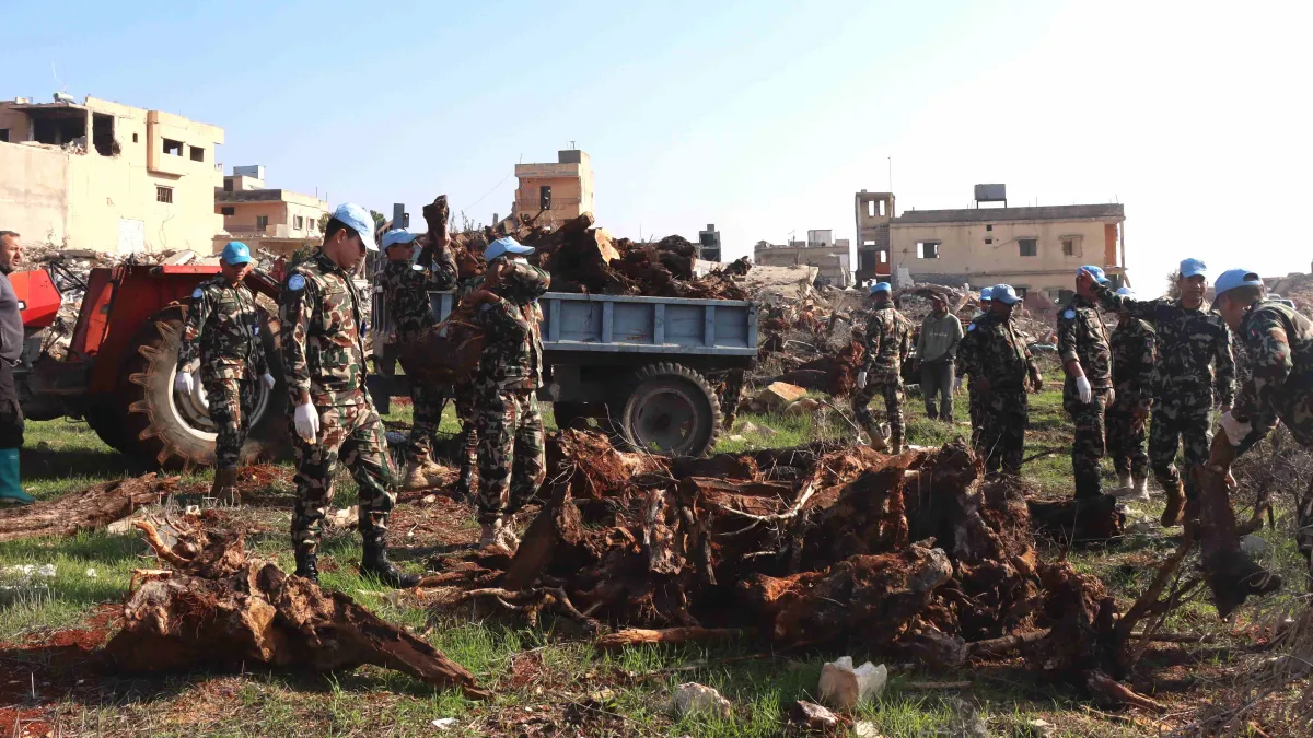 Peacekeepers assist Blida residents to prepare field for olive plantation