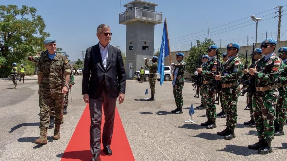 Jean-Pierre Lacroix walks alongside peacekeepers.