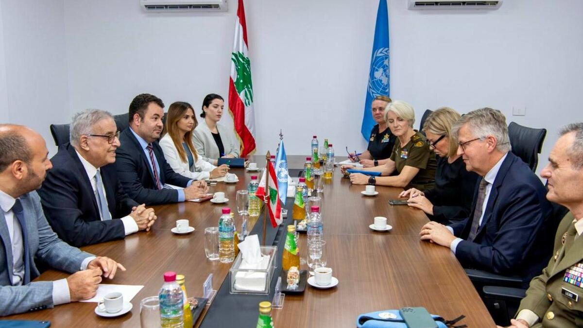 High level representatives attend a meeting around a formal table.