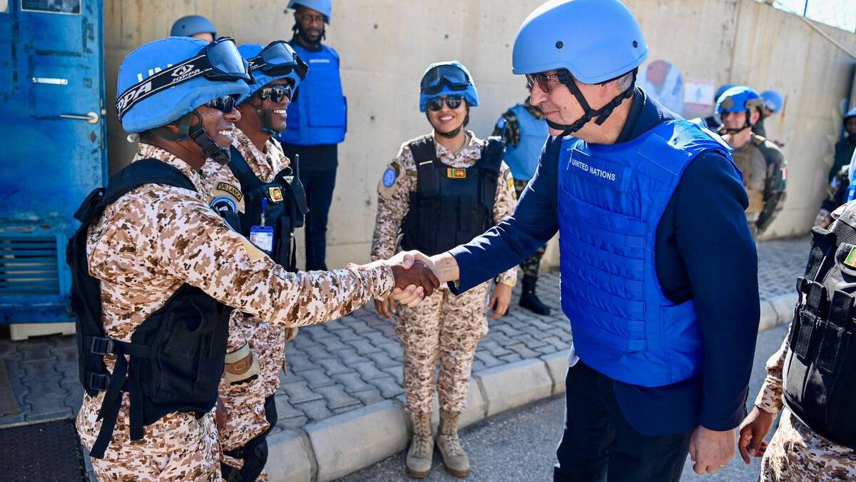 Jean-Pierre Lacroix shakes hands with a peacekeeper.