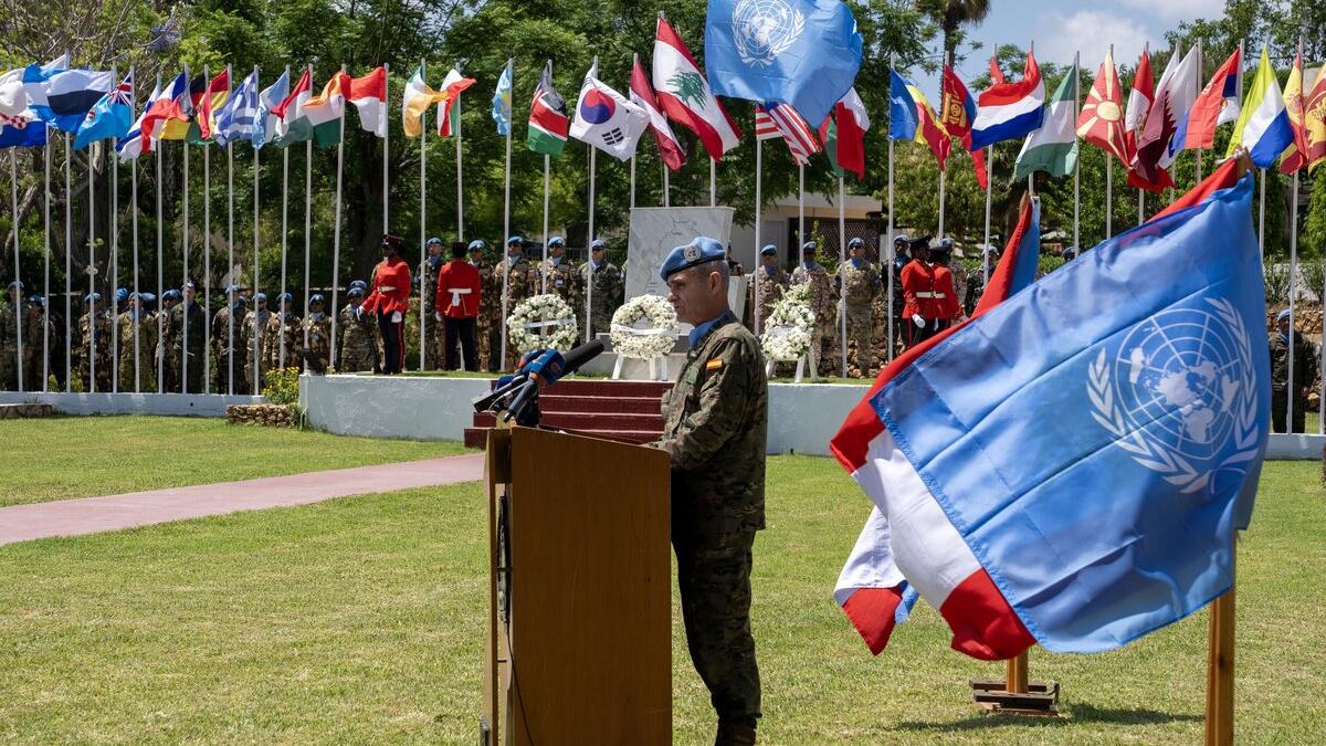 A representative at a podium addresses a crowd.