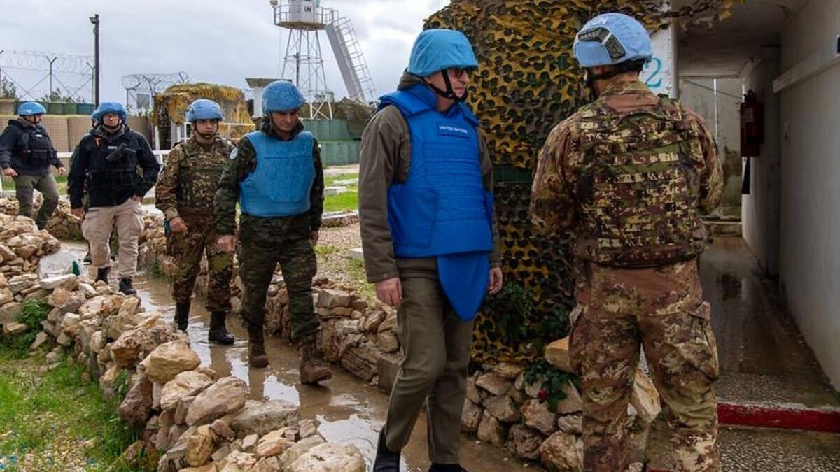 Jean-Pierre Lacroix and peacekeepers enter a site.
