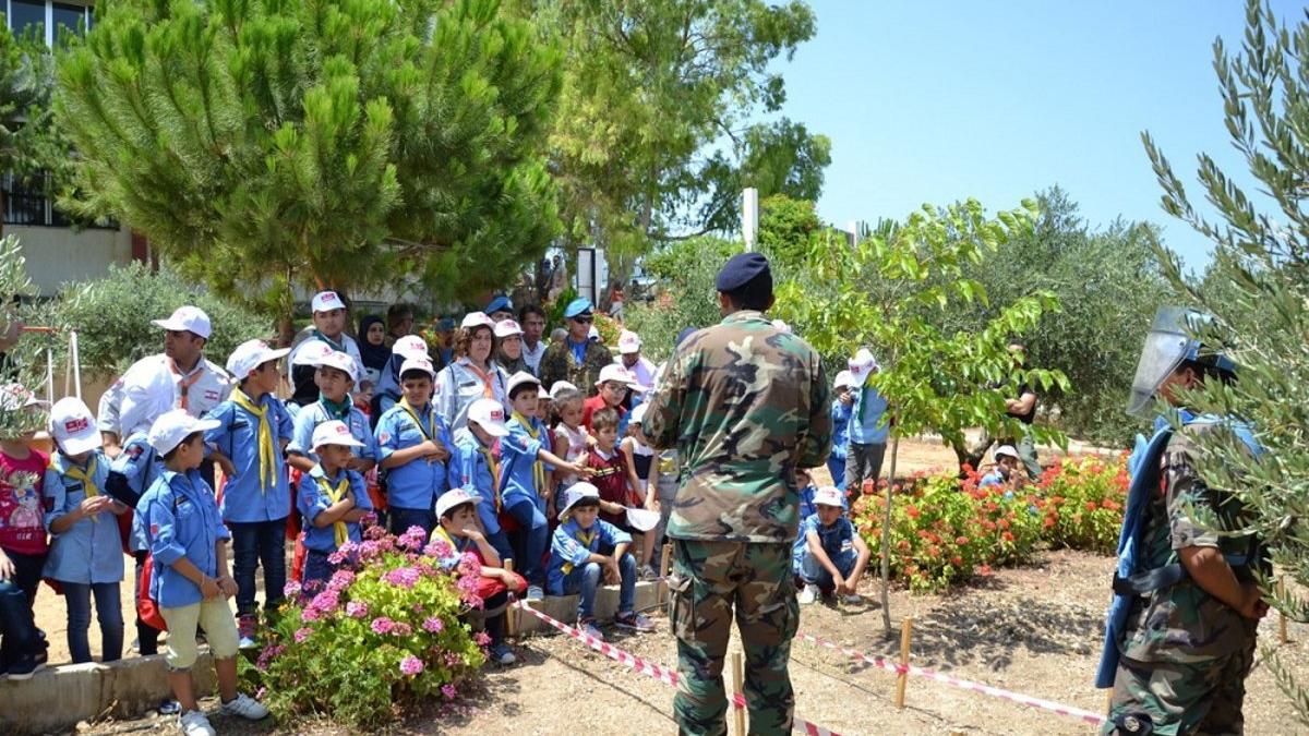 Peacekeepers address a group of children.