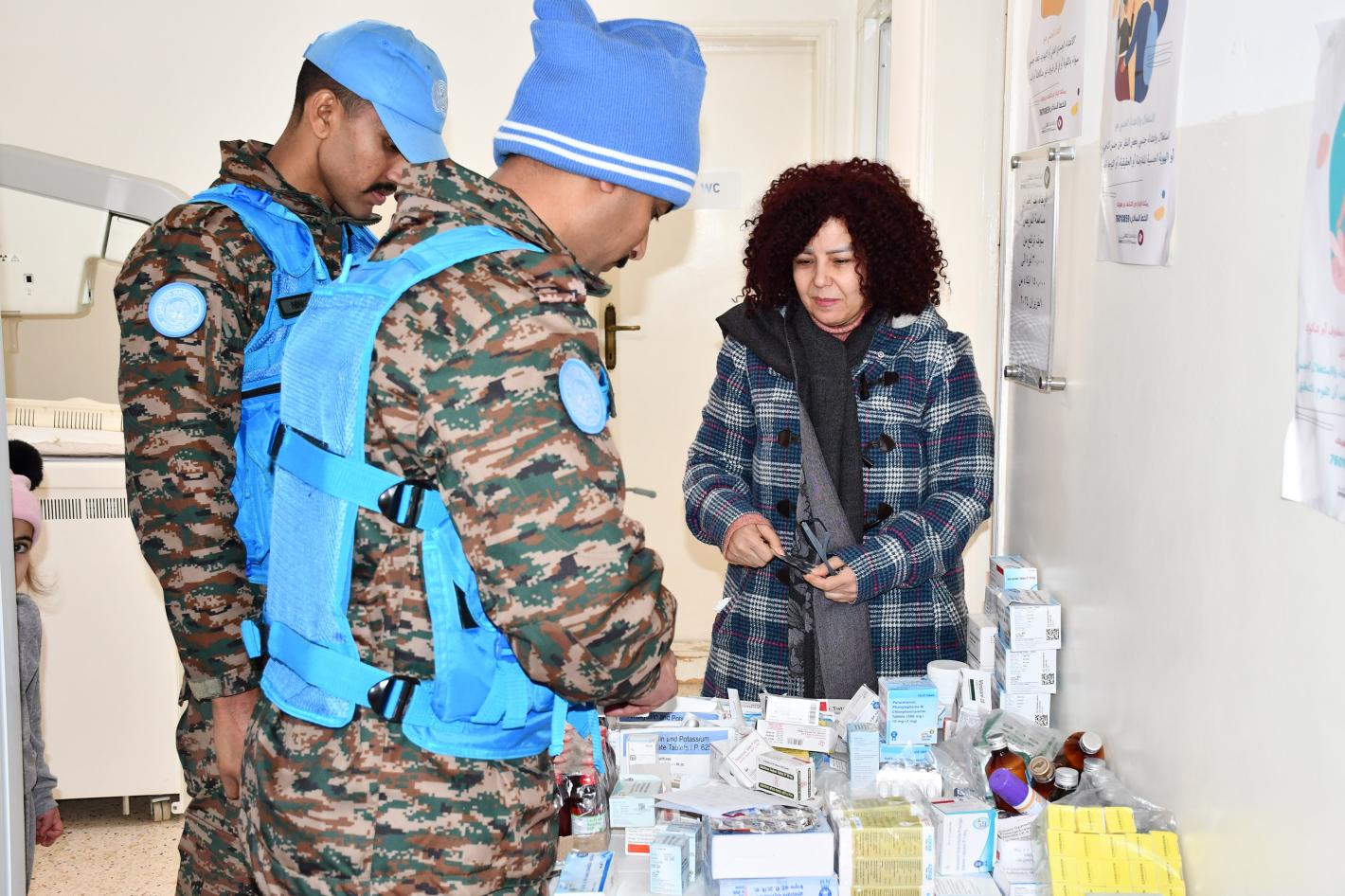 Peacekeepers handing medical supplies to a civilian