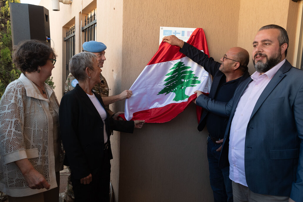 group of people unveiling a sign