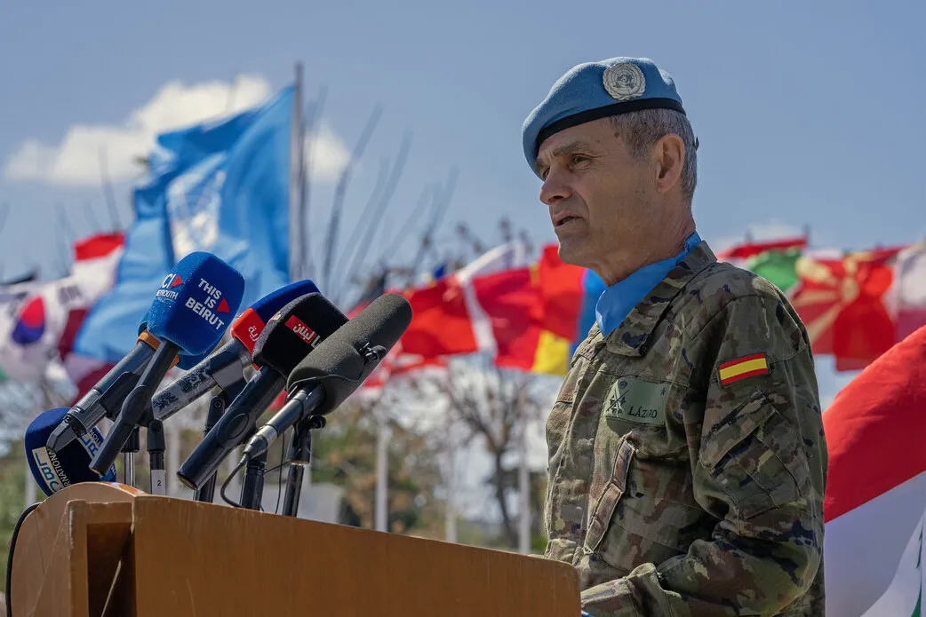 The Force Commander speaks at a podium.