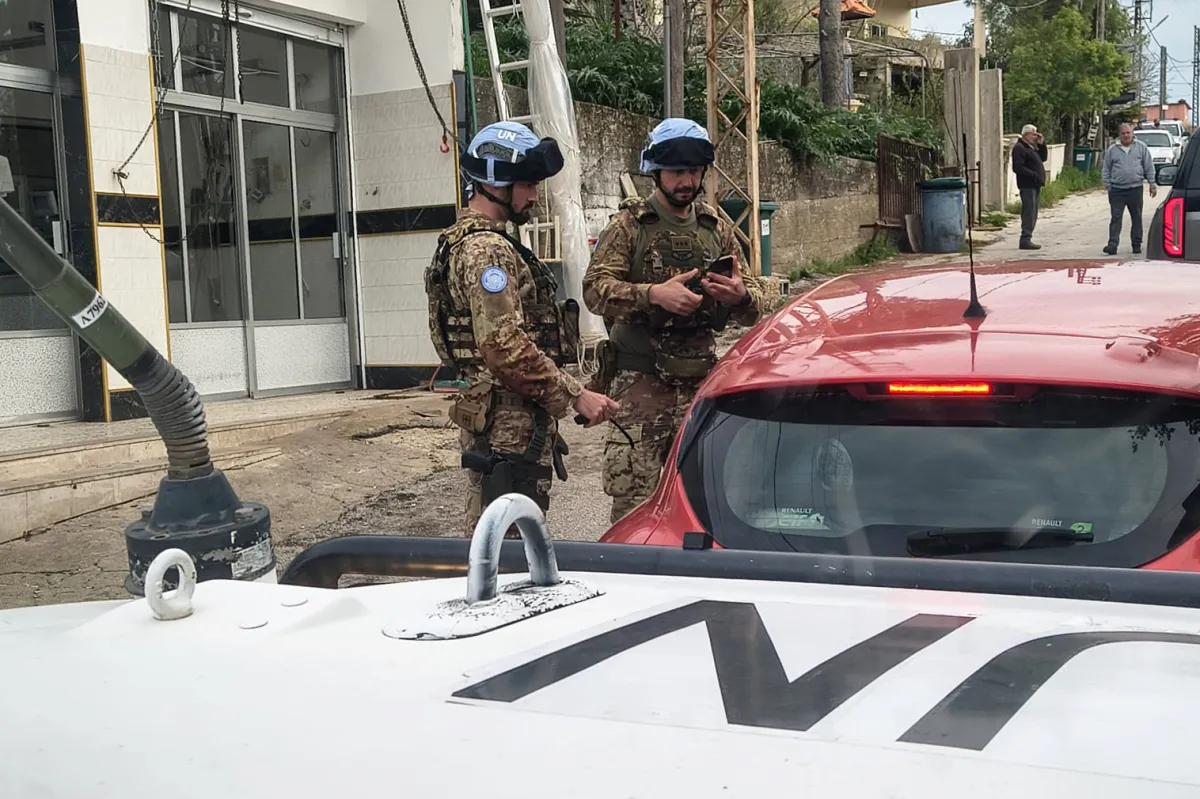 italian peacekeepers escort displaced persons from Debel 2