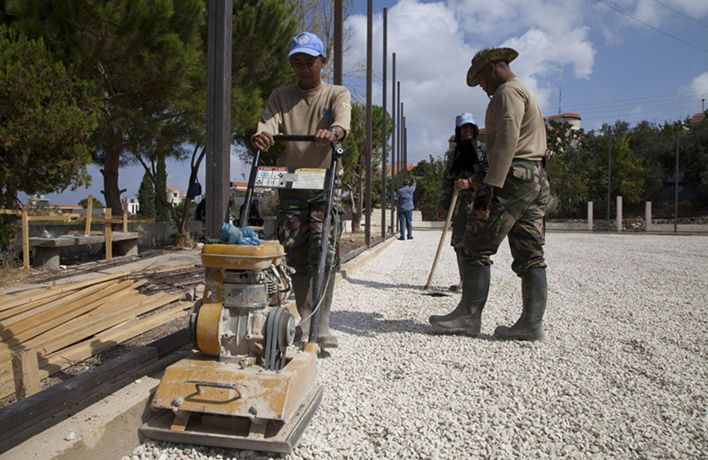 UNIFIL Malbatt engineers leveling ground of newly built field.