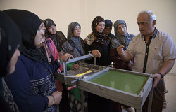 Teacher talking to women from Ramieh village about soap making process, in south Lebanon.